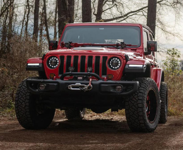 A photo of a red Jeep equipped with Morimoto lighting solutions.