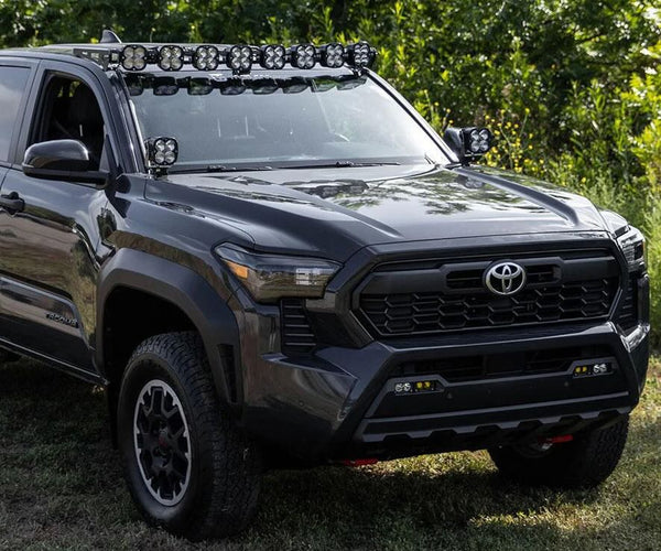Photo of a Toyota Tacoma with a Baja Designs lighting kit on the roof.