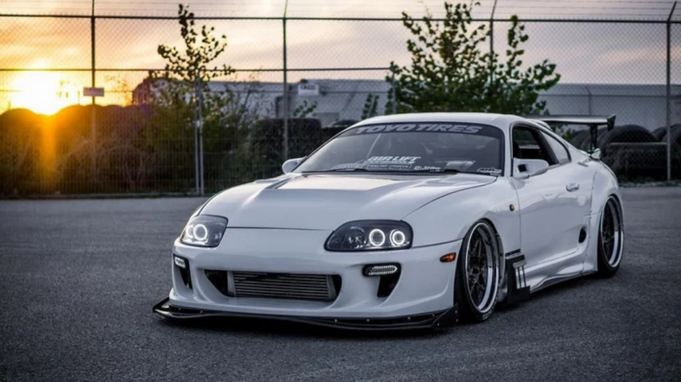 White sports car with LED lighting at sunset