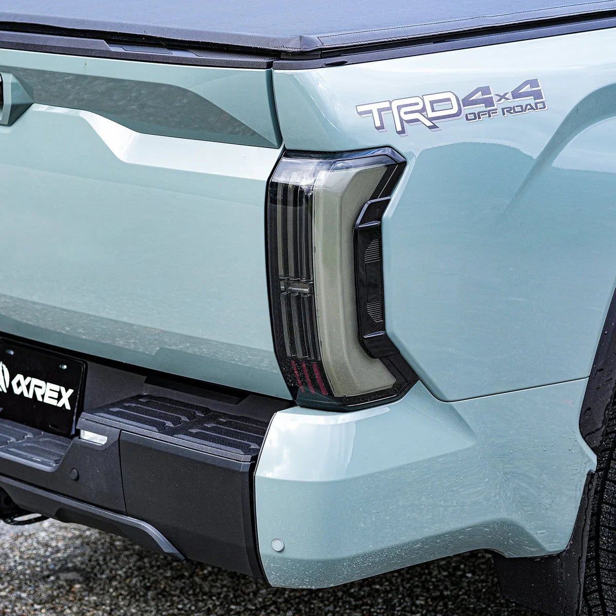 AlphaRex Nova-Series LED tail lights on a Toyota Tacoma featuring the signature activation light sequence and 3D Ice Cube projectors. Best prices at OffRoadUSA.