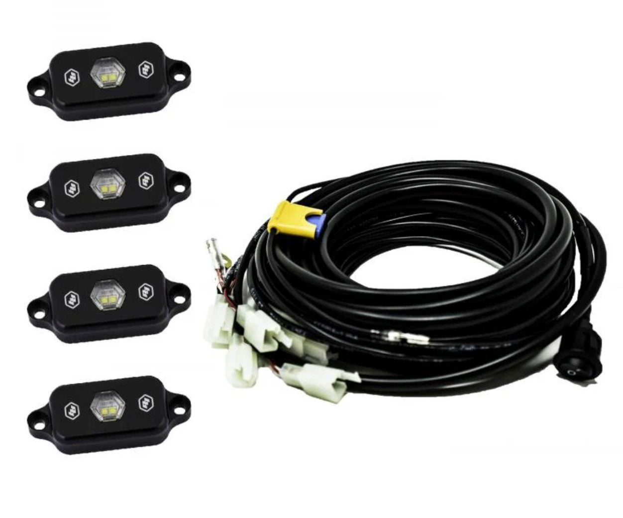 Baja Designs Zone 6 white LED rock lights illuminating the front suspension and tires of a Toyota 4Runner at night. Best prices at OffRoadUSA.