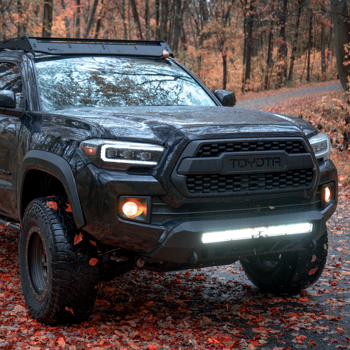 built out toyota tacoma with heavy duty front bumper, prinsu roof rack, very bright LED light bar and LED headlights 