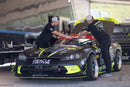 2 People working on a car, both wearing ORACLE Lighting Official Snap-Back Hat.