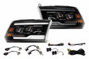 Pair of car headlights with wiring harnesses on a white background