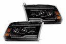 Pair of black car headlights on a white background