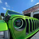 Close-up on a ColorSHIFT Oculus Headlight installed on a Jeep, with green halos on.
