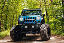 Front end of a Jeep Wrangler JK with white LED headlight and fog light halos installed.