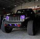 Front end of a Jeep Wrangler JK with purple LED headlight and fog light halos installed.