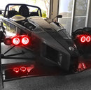 Ariel Atom with red headlight halos.