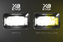 Two XB EVO fog lights, one white and one white/yellow, on a dark background.