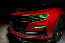 Front end of a red Chevrolet Camaro with green headlight DRLs.