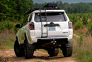 White 2024 Toyota 4Runner with Morimoto XB LED Tail Lights (GEN II) carrying off-road equipment on a dirt road surrounded by greenery.