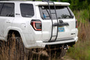White Toyota 4Runner with a ladder rack in a natural setting, along with glowing red Morimoto XB LED Tail Lights (GEN II)