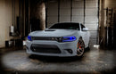 Three quarters view of a grey Dodge Charger with blue headlight DRLs.