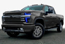 Three quarters view of a Chevy Silverado with blue headlight DRLs.