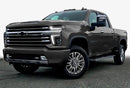 Three quarters view of a Chevy Silverado with white headlight DRLs.