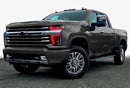 Three quarters view of a Chevy Silverado with red headlight DRLs.