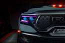Close-up of Ram 1500 headlights with purple DRLs and cyan demon eye projectors.