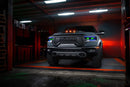 Front view of a Ram 1500 with blue headlight DRLs and green demon eye projectors.