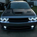 Silver dodge challenger with white headlight and fog light halos