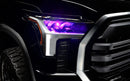 Close-up of a 2022+ Toyota Tundra headlight module installed with pink demon eye projector.