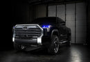 Three quarters view of a black Toyota Tundra with blue demon eye projectors.