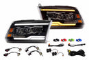 Pair of car headlights with wiring harnesses on a white background