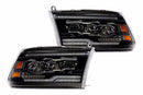 Pair of black car headlights on a white background