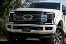 Photo of a Ford Super Duty pickup truck with Morimoto XB EVO Hybrid LED Headlights parked in front of trees.