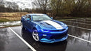 Three quarters view of a Chevrolet Camaro with blue headlight and fog light DRLs.