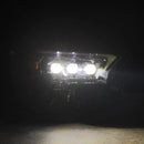 A photo of a lit AlphaRex 24-25 Toyota Tacoma / 25-up 4Runner NOVA-Series LED Projector Headlights Black