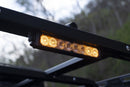 Amber LED light mode on the ss10 chase light, mounted on a vehicle roof with a blurred natural background