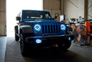 Three quarters view of a Jeep Wrangler with white LED headlight and fog light halos installed.