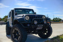 Three quarters view of a Jeep Wrangler JK with white LED headlight halos installed.