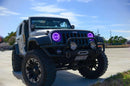 Three quarters view of a Jeep Wrangler JK with purple LED headlight halos installed.