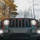 Front end of a Jeep Gladiator JT with amber Pre-Runner Style LED Grill Light Kit installed.