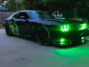 Three quarters view of a black Dodge Challenger with green LED headlight and fog light halo rings installed.