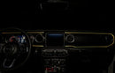 The dashboard of a Jeep with ColorSHIFT Fiber Optic LED Interior Kit installed, glowing yellow.