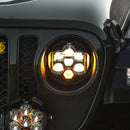 Close-up of a fog light with additional lights attached, on a dark background from the Baja Designs DOT LP6 LED Headlight Kit.