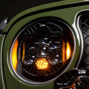 Close-up of a car's headlight with LPG (Liquid Petroleum Gas) indicator on a green vehicle.
