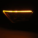An amber signal light in an AlphaRex 24+ Toyota Tacoma / 25-up 4Runner OG-Style LUXX-Series LED Projector Headlights Black