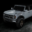 Three quarters view of grey Ford Bronco with Triple LED Fog Lights turned on.