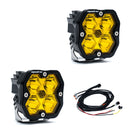 Two yellow LED lights (Baja Designs Squadron 2.0 Sport pods) with black housing and wiring on a white background