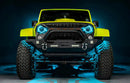 Front view of a yellow Jeep with 7" Oculus Headlights installed, set to cyan LEDs.