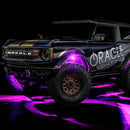 Three quarters view of wrapped Ford Bronco with pink LED rock lights installed