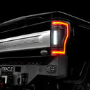 Close up on the rear end of a black Ford Superduty with Flush Mount Tail Lights installed, and reverse lights on.