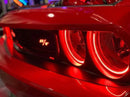 Close-up of challenger headlights with red halos