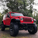 Three quarters view of a red Jeep Wrangler with Oculus Headlights installed.