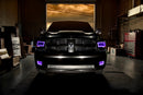 Front end of a RAM truck with Switchback Quad Pre-Assembled Halo Headlights installed and purple halos on.