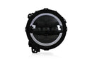 Black round headlight with LED ring on a white background